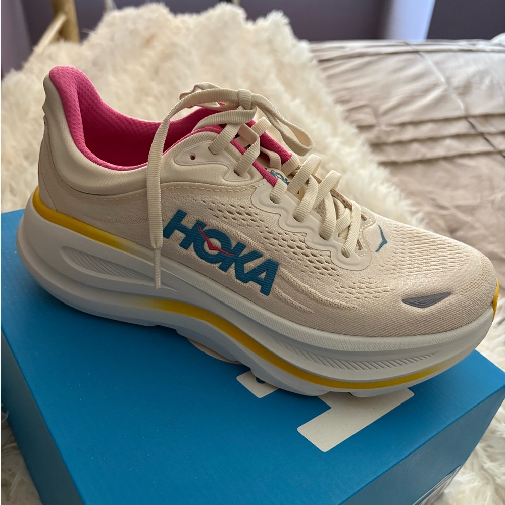 Hoka Women's Cream Running Shoe with Pink Lining and Blue Logo. Brand new